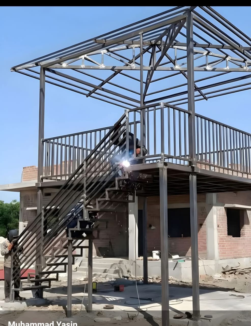 Modern steel carport structure beside a residential building