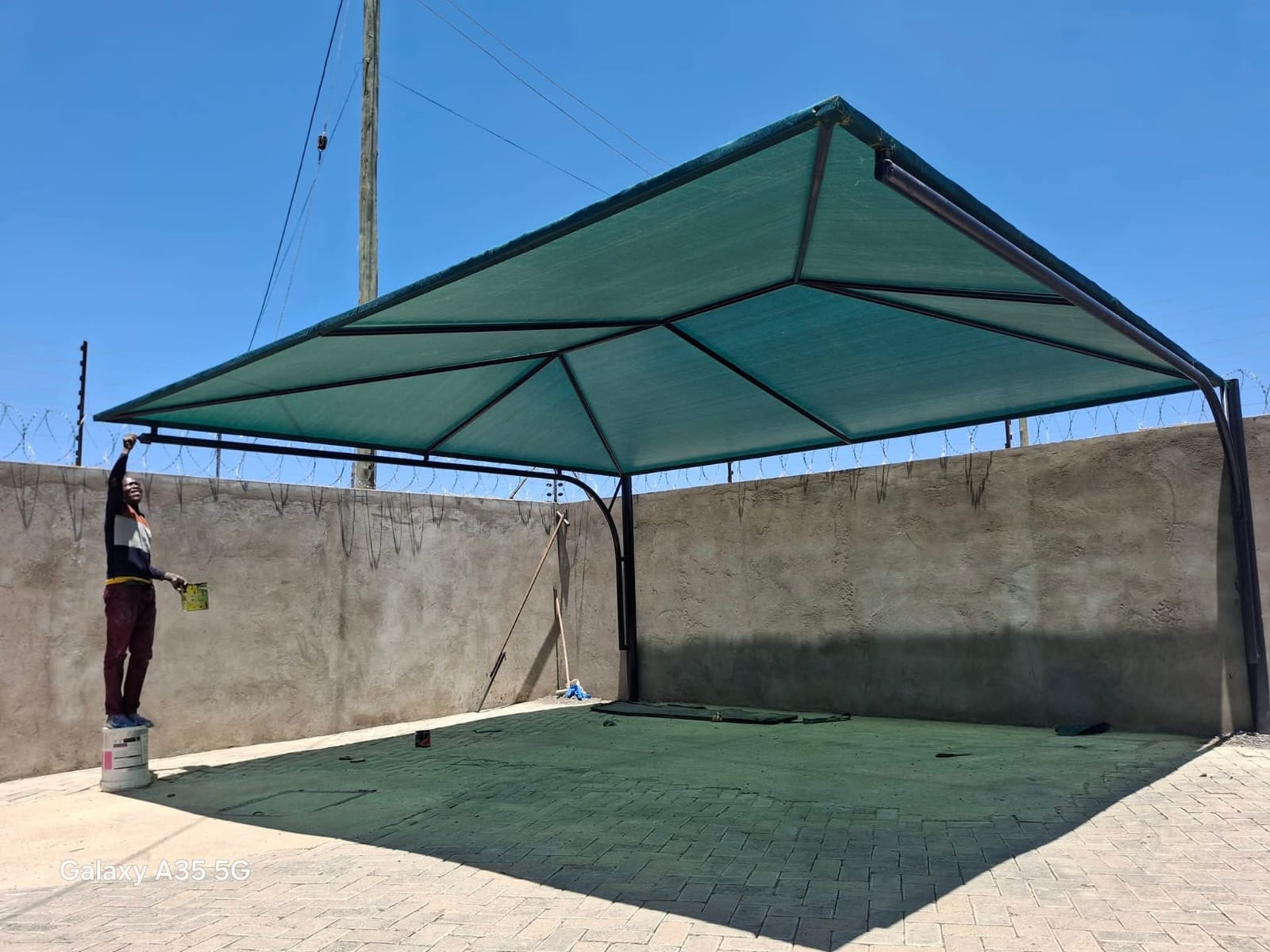 Modern steel carport structure beside a residential building